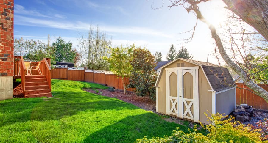 Fenced backyard with storage shed in Lancaster